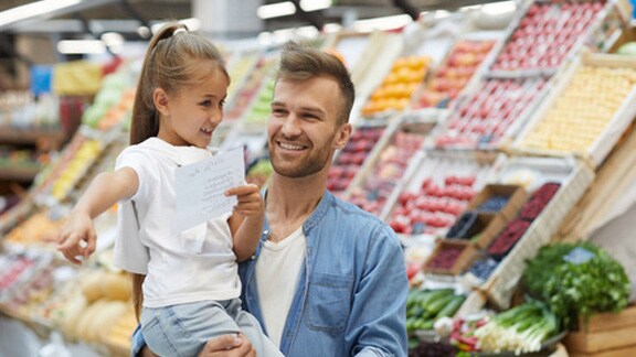 Father And His Daughter In A Supermarket