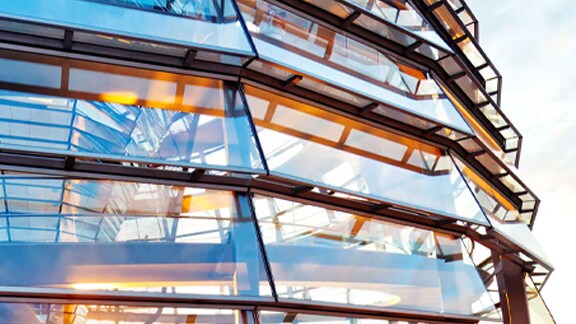 Exterior view of a circular corporate building with glass windows