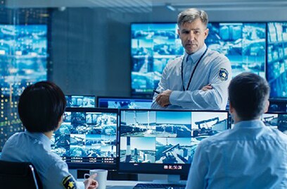 Security employees discussing the work in the security control room