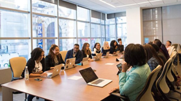 A group of employees discussing in a conference room